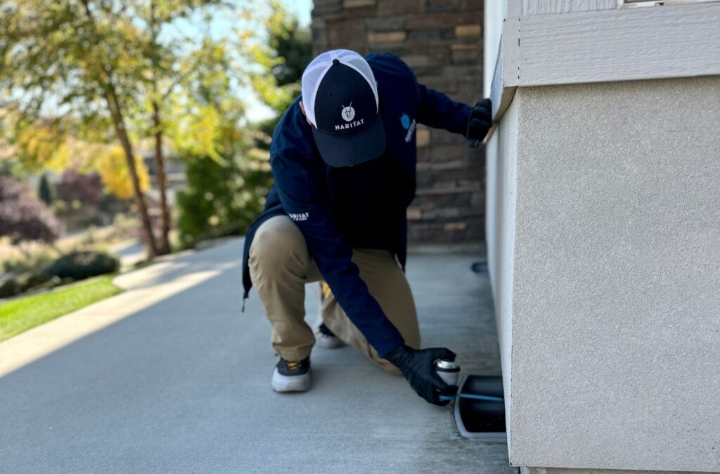 A Habitat Pest & Lawn expert applying pest control solutions in Marsing, ID, focusing on safety and effective pest removal.